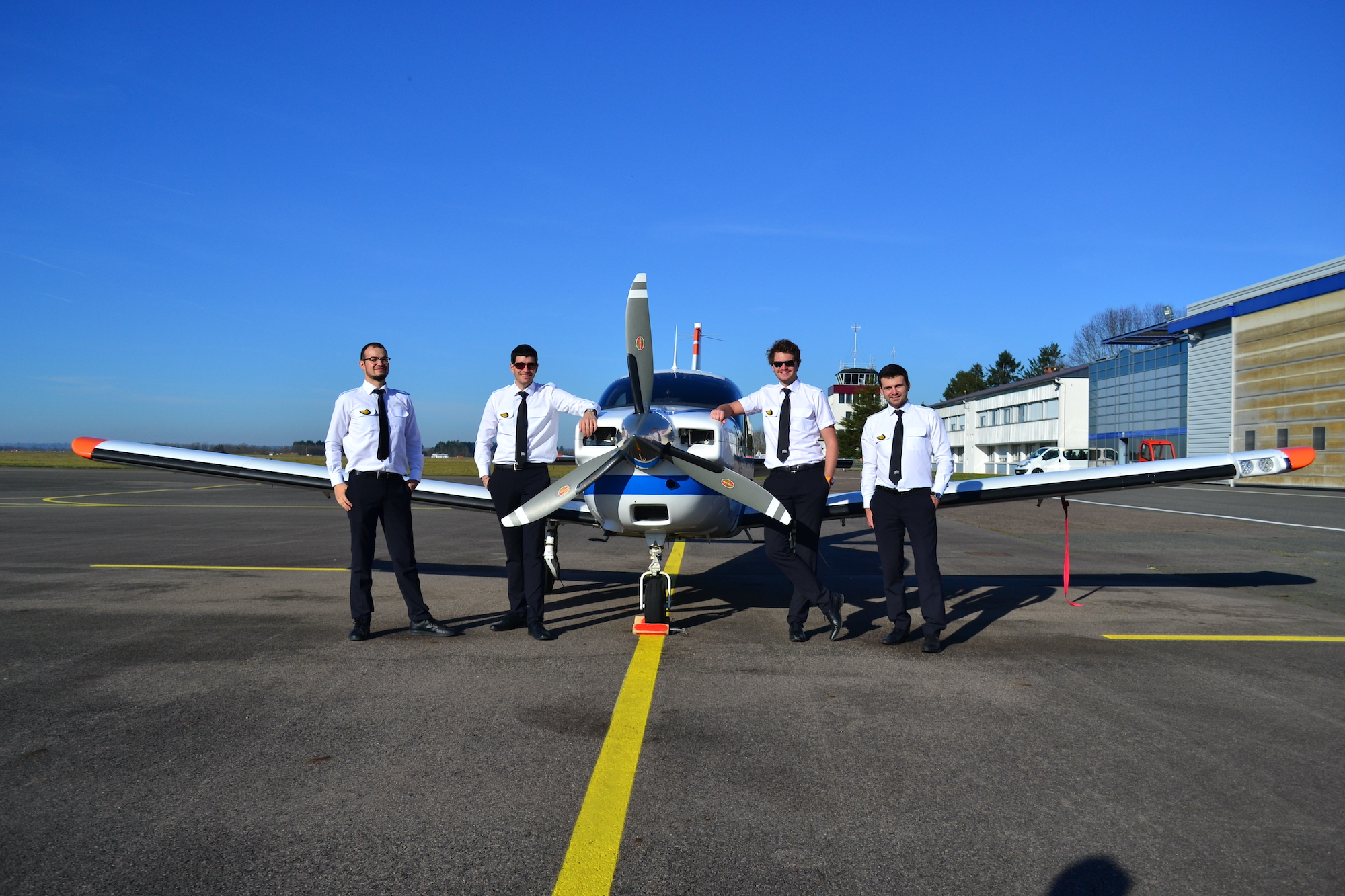 An EPL flight group posing next to their TB20 seen from the front